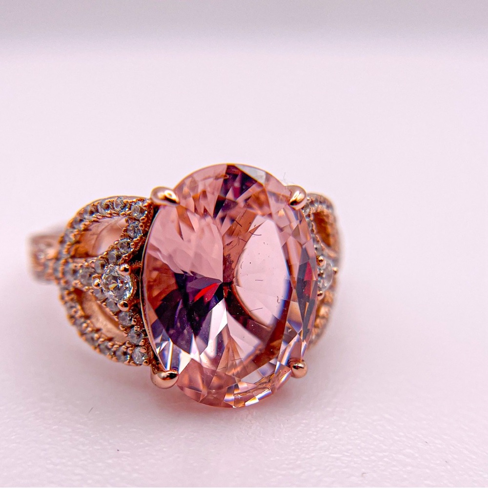 Rose gold colored ring with pinkish oval cut stone